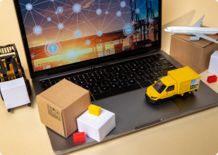 a laptop with a toy truck on it